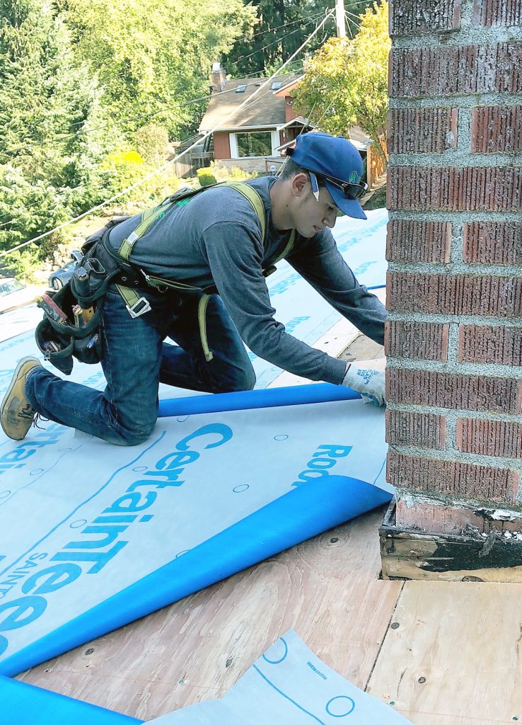 Roofers hard at work replacing a roof