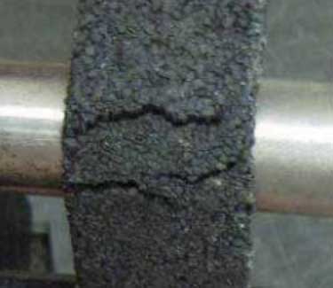 Non-modified asphalt shingle with cracking