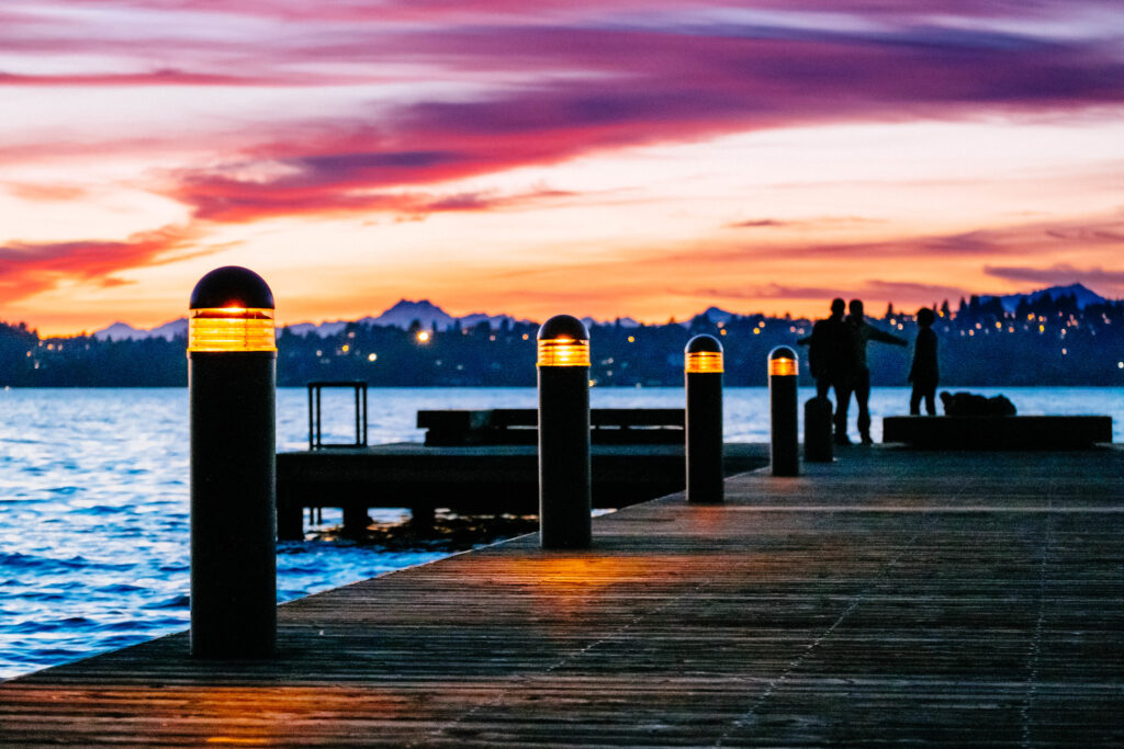 A stunning Kirkland marina sunset showing the dock with piling cap lighting.