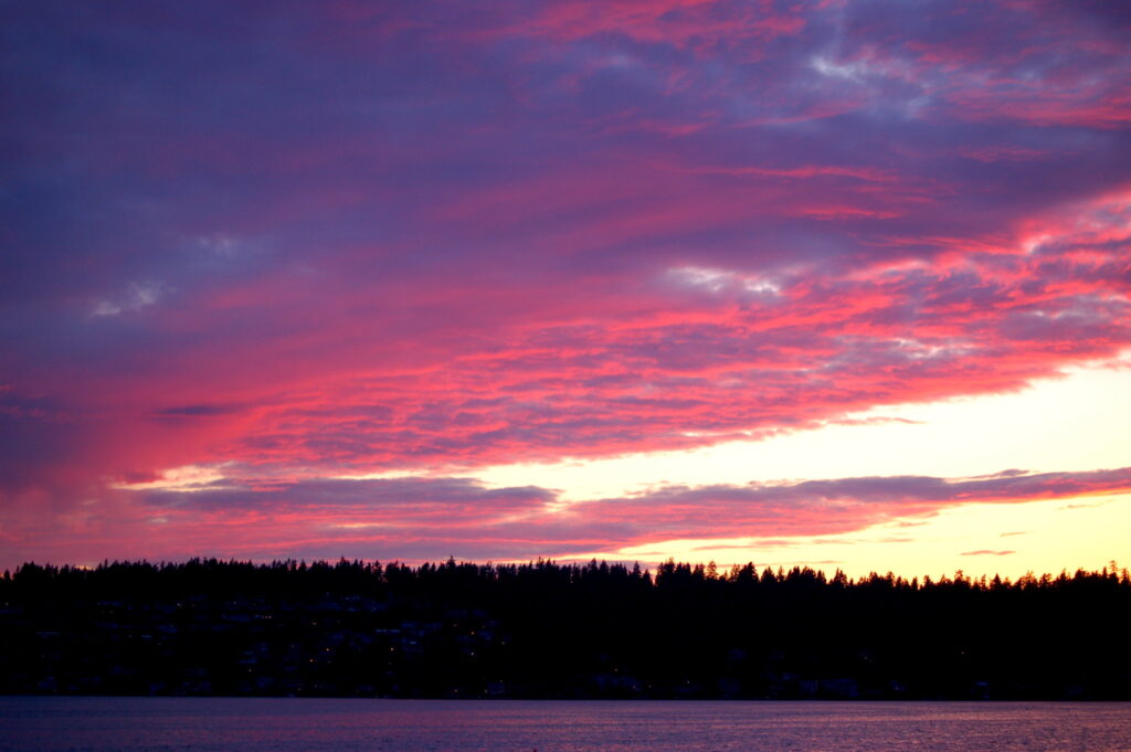 A vibrant fuscia and yellow sunset over Lake Sammamish, Washington