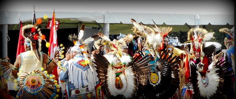 Muckleshoot Pow Wow with tribal dance, singing and traditional clothing and headdresses.
