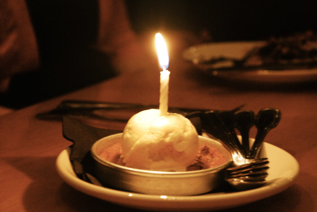 A birthday Pizookie dessert with a lighted candle on top from B.J.'s