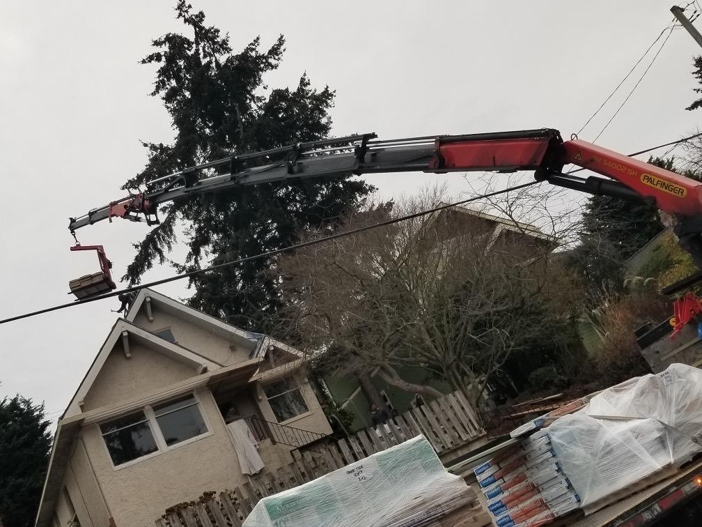 Crane Dropping off Materials for a Roof Replacement setup in seattle