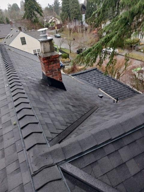 new asphalt shingle roof with new chimney flashing