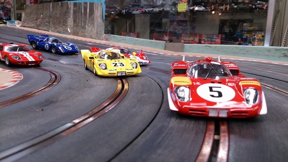 Slot cars racing on a track.
