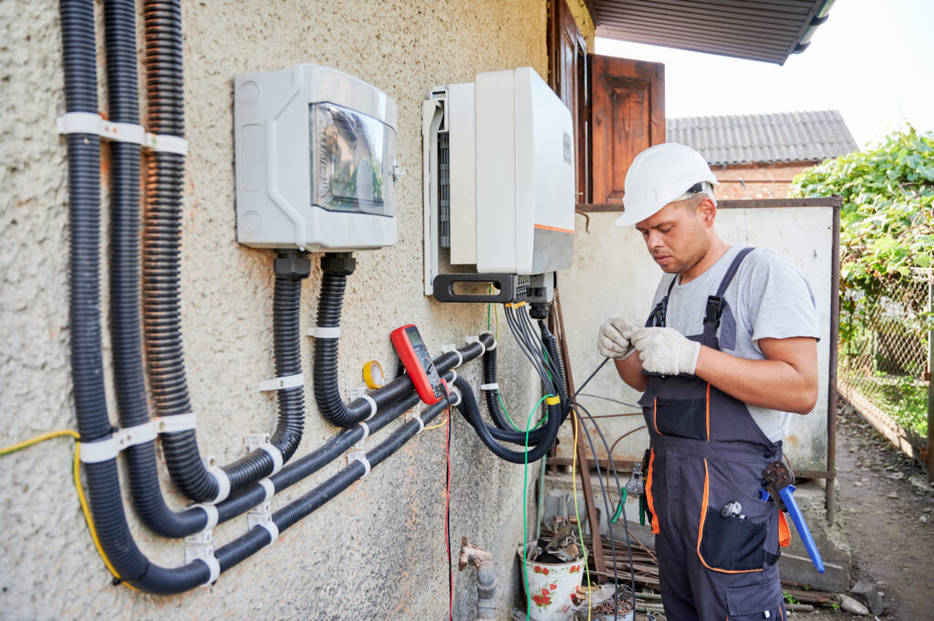 Electrician installing solar panel system, proper electrical wiring is a critical aspect of a solar installation.