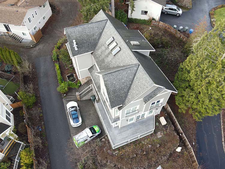 Before and After of New Metal Roof in Bellevue, Washington - Before image of top of roof from an angle