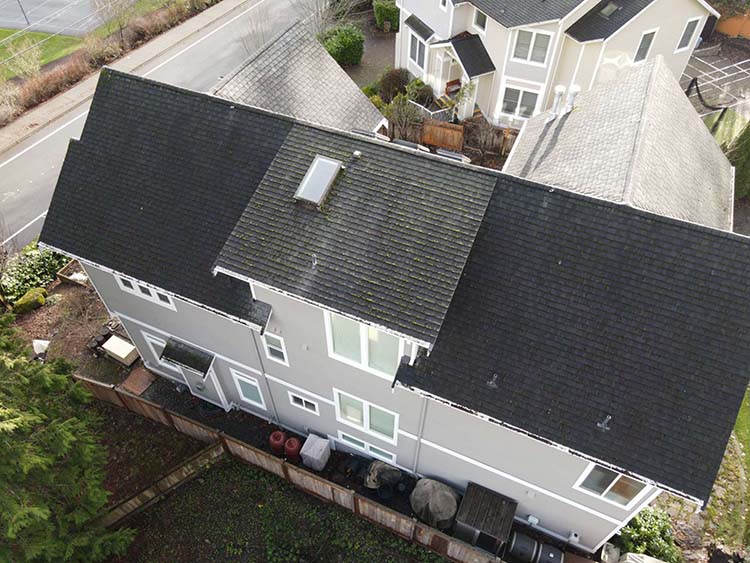 Before and After of New Metal Roof in Bellevue, Washington - Before image of top of roof