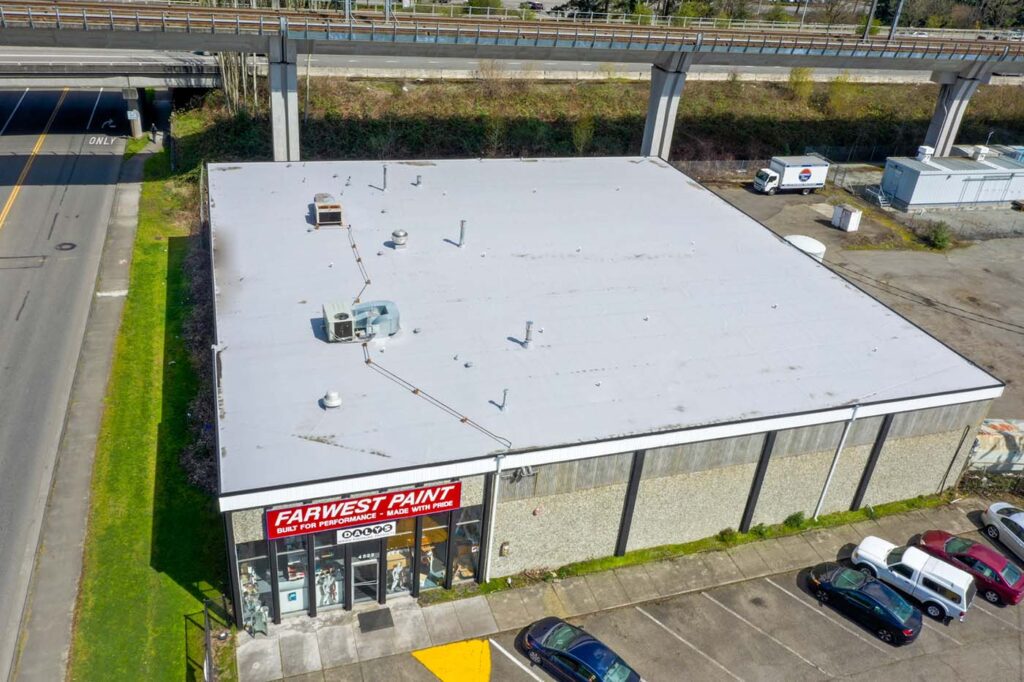 New Flat TPO Roof for Commercial Building in Tukwila, Washington - view of new roof and front of commercial building from an angle