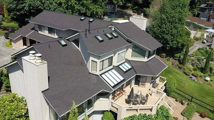 New Composite Asphalt Shingles Roof in Mercer Island, Washington: close up view of back of house roof skylights, vents, ridgelines and other roof features.