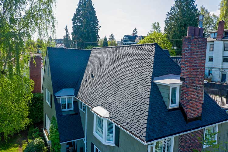 New Composite Asphalt Shingles Roof in Tacoma, Washington: close up view of roof dormer and chimney
