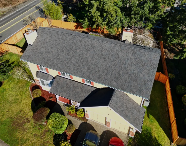 Angled aerial view from the front of the house highlighting the composite asphalt shingle roof in Auburn, Washington.
