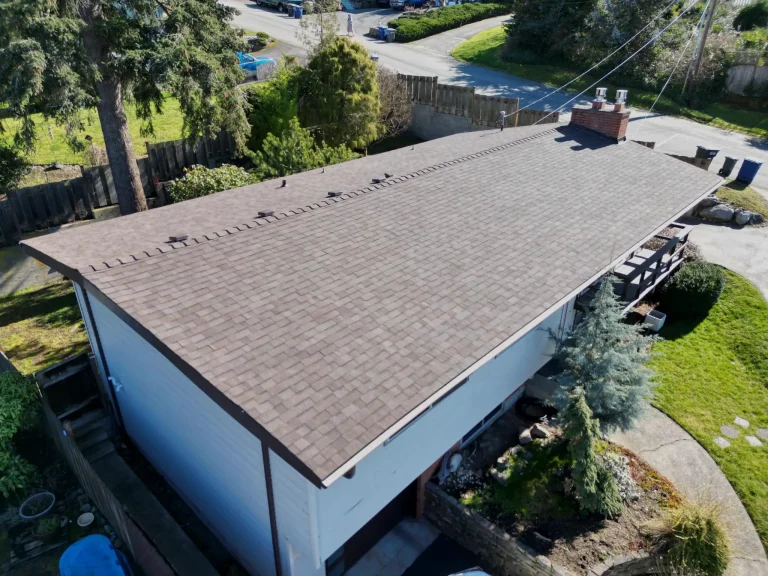 Aerial view at an angle from the front of the home of the lower pitch composite asphalt shingle roof in Des Moines, Washington.