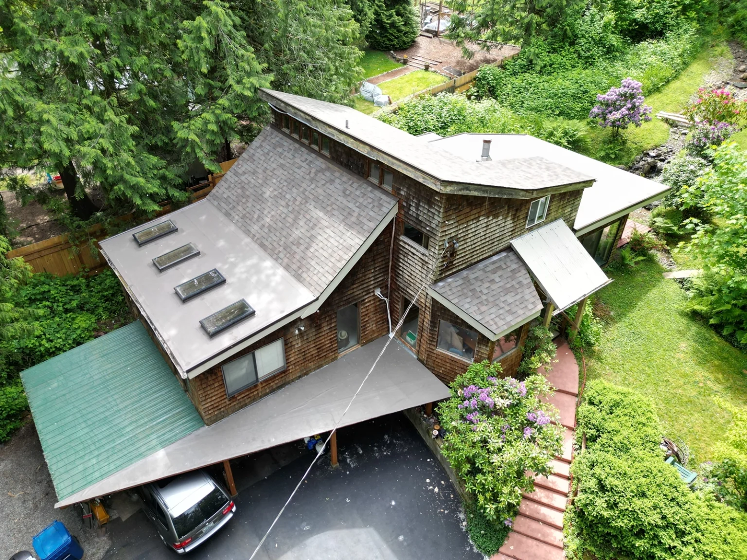Overhead view of the front of the a house with a new roof with a No Attic Composite Asphalt Shingle & Flat TPO Roof - Issaquah, Washington
