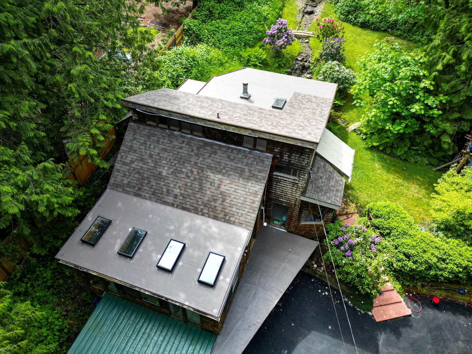 Overhead view from a slight angle of new roof on a house with new skylights and No Attic Composite Asphalt Shingle & Flat TPO Roof - Issaquah, Washington