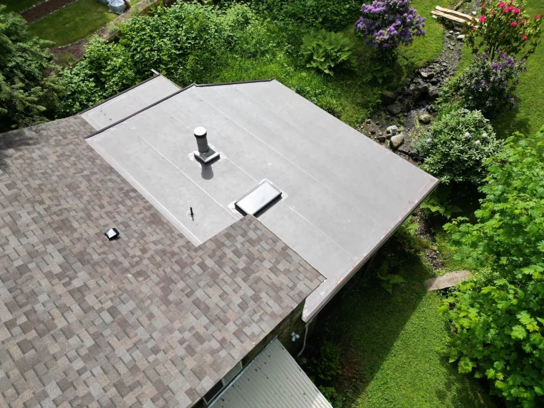 Close up view of a flat roofing portion of a new No Attic Composite Asphalt Shingle & Flat TPO Roof - Issaquah, Washington