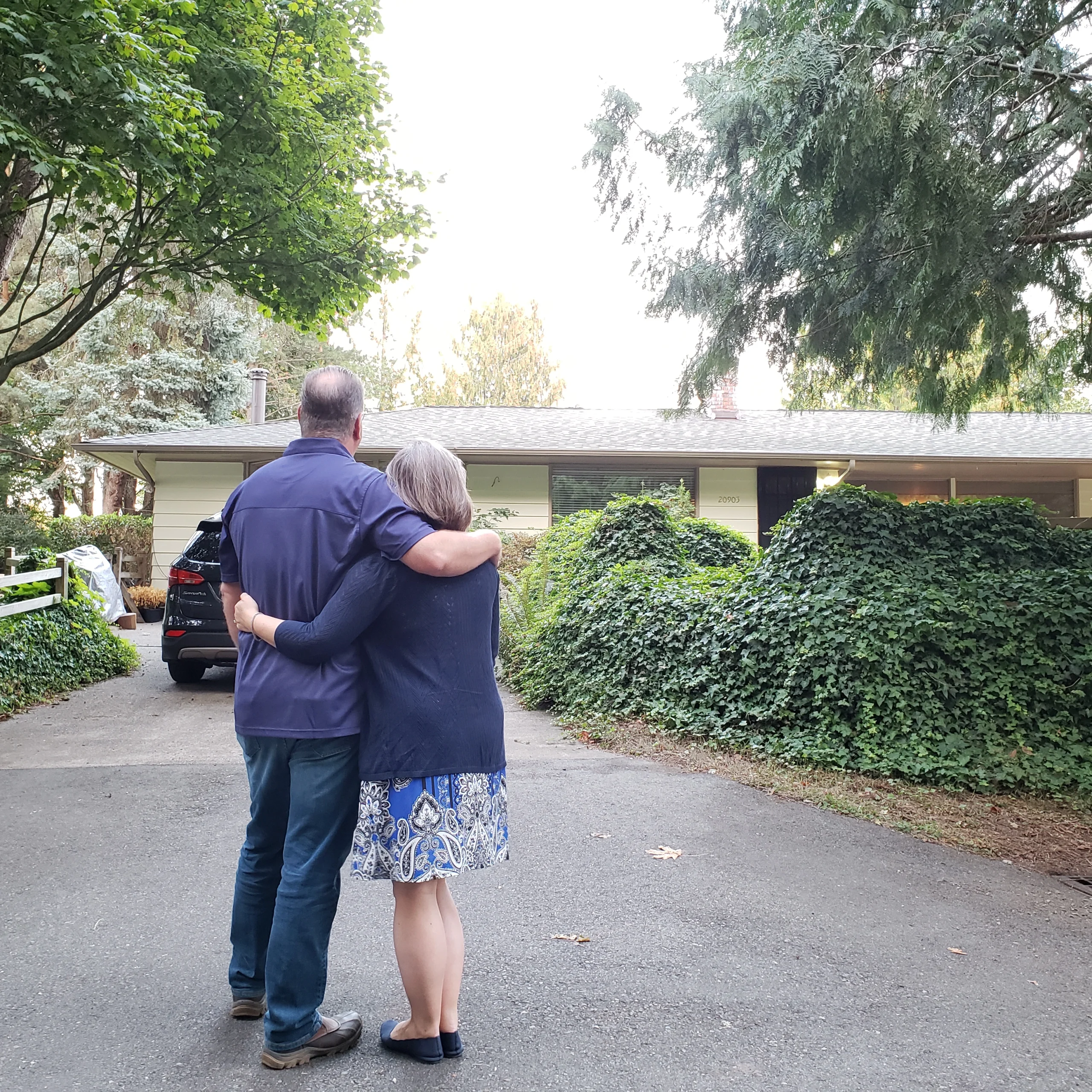 Happy home owners enjoying their new roof that started with a free roofing estimate.