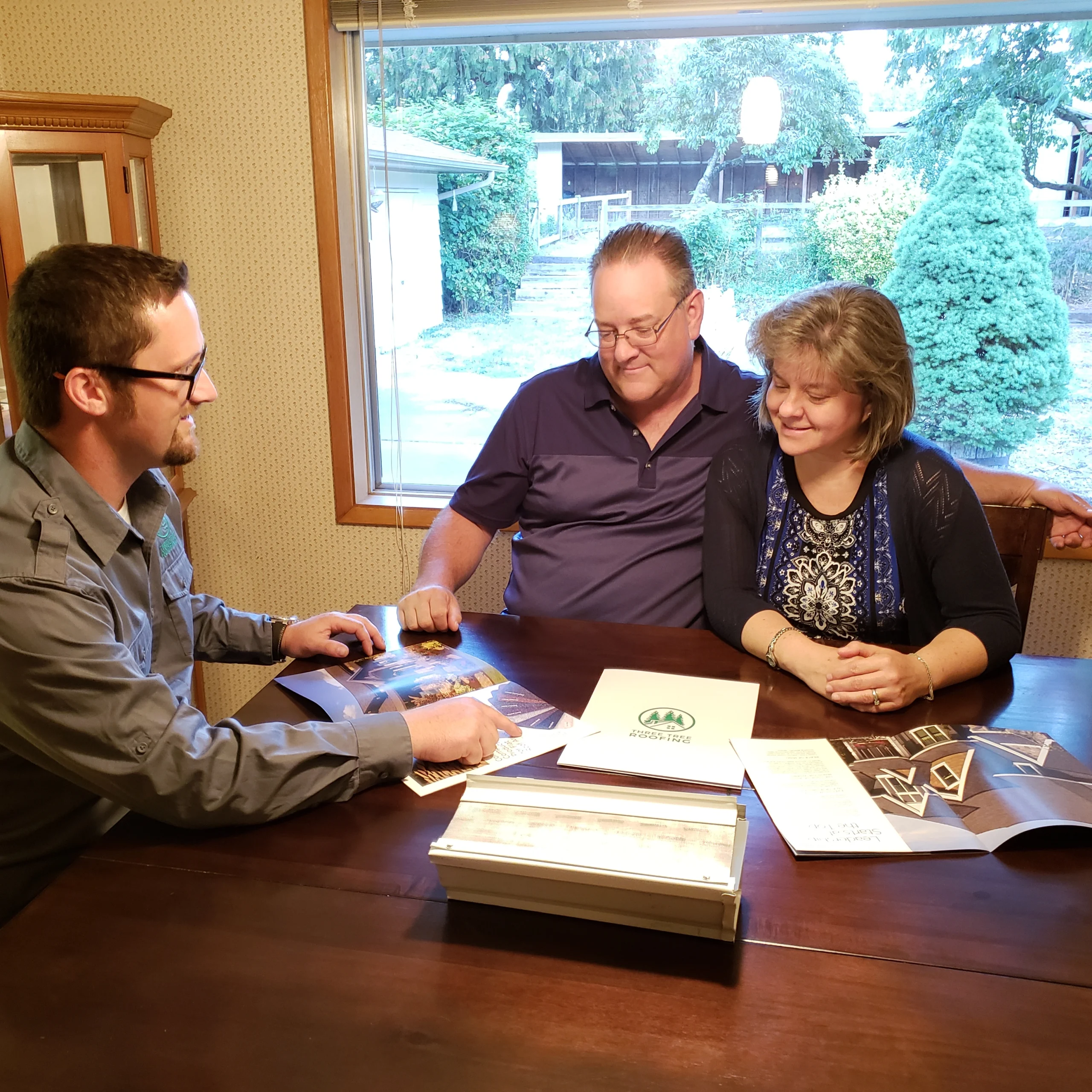 Three Tree Roofing meeting with home owners and providing a free roofing estimate.