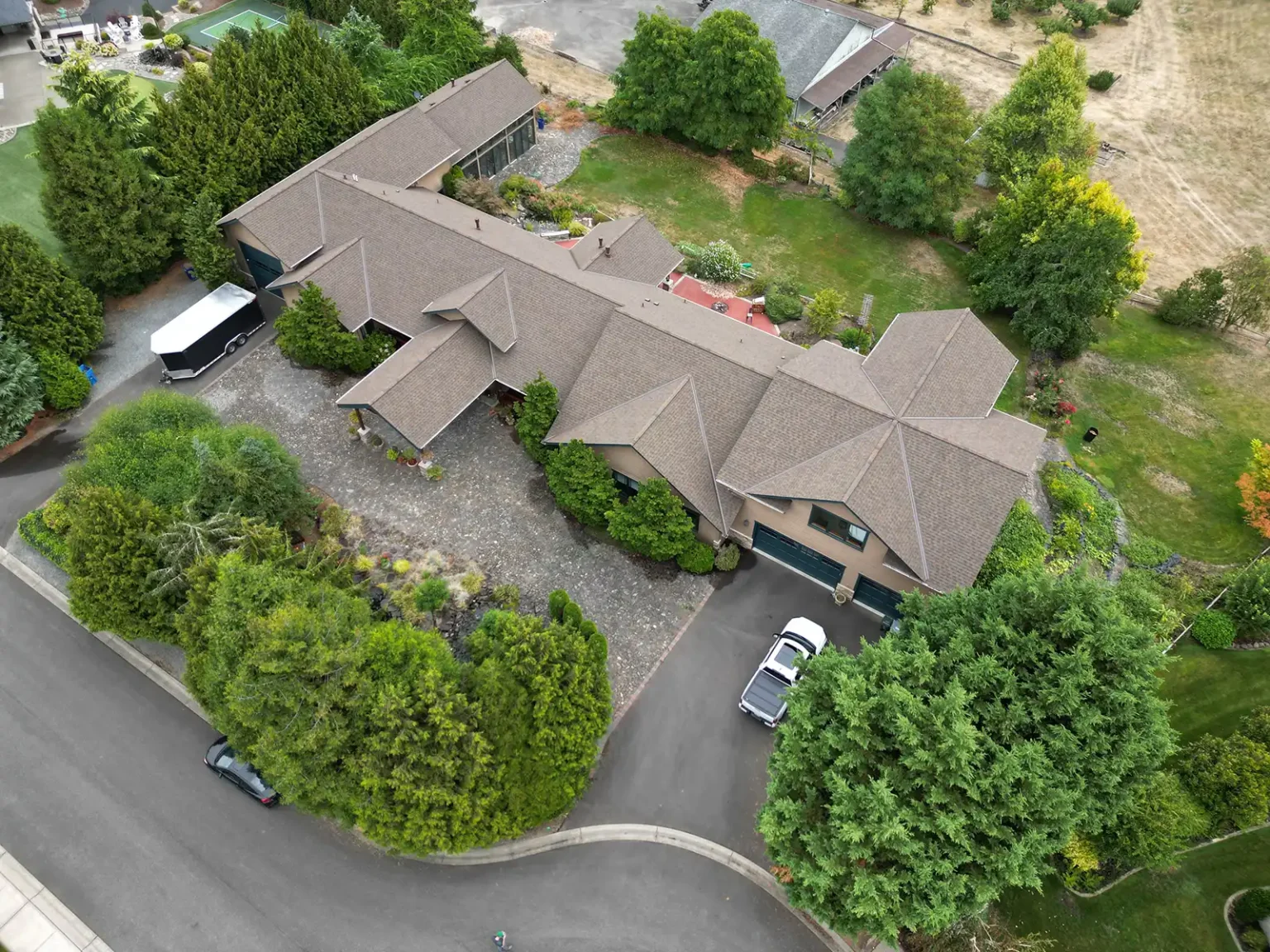 Overhead view from an angle of a large complex roof with valleys in Tacoma, Washington