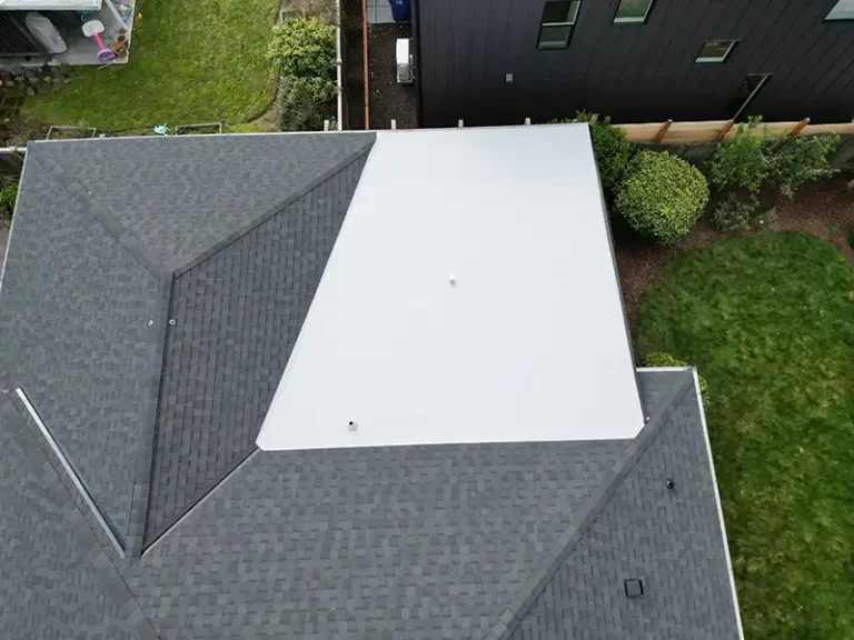 Close up view of top flat roof section of a home with a New Composite Shingle with Flat Roof in Seattle, Washington