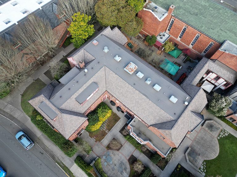 View from an angle of a building with a Synthetic Shake Shingle Church and School Roof in Seattle, Washington